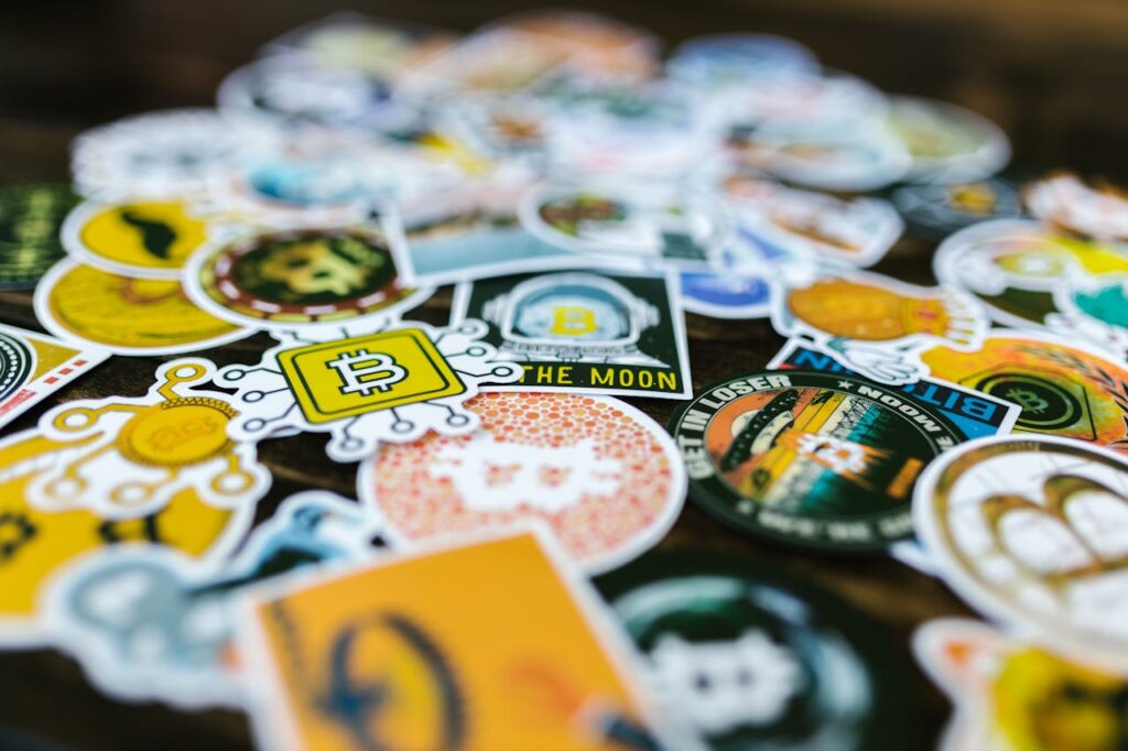 Vibrant Bitcoin and cryptocurrency-themed stickers scattered on a surface.
